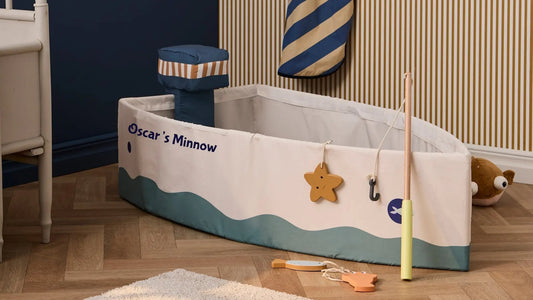 A play fishing boat in a child's room. The boat has Oscar's Minnow printed on the side