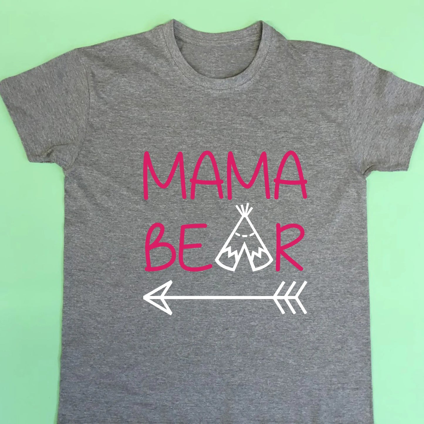 Grey adult t shirt with top line of text reading Mama and the second reading bear but with the a replaced with a teepee and an arrow under the whole design. Printed in two colours text printed in fuchsia pink and teepee and arrow in white.
