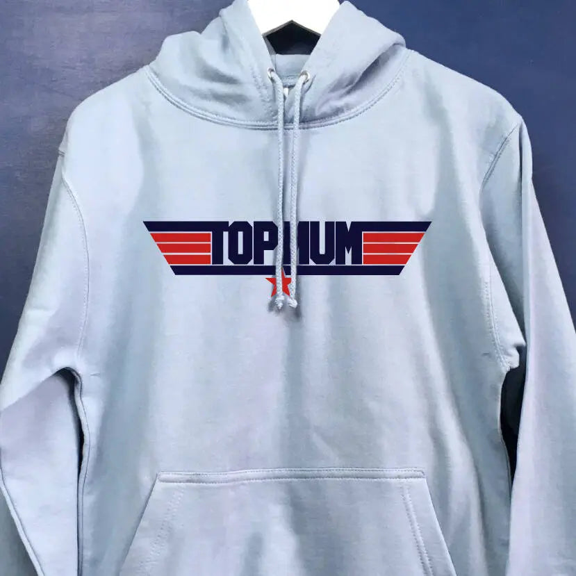 Light blue hoodie with a navy and red top gun style design printed on the front. Instead of top gun it reads top mum