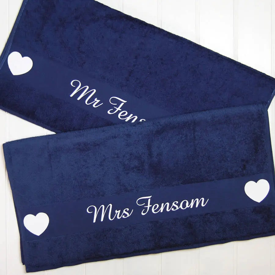 Two navy towels printed with the names Mr Fensom and Mrs Fensom on each with hearts at either end of names