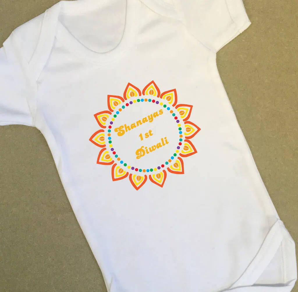 White babygrow with a colourful Diwali design and the text Shanayas 1st Diwali printed on the front