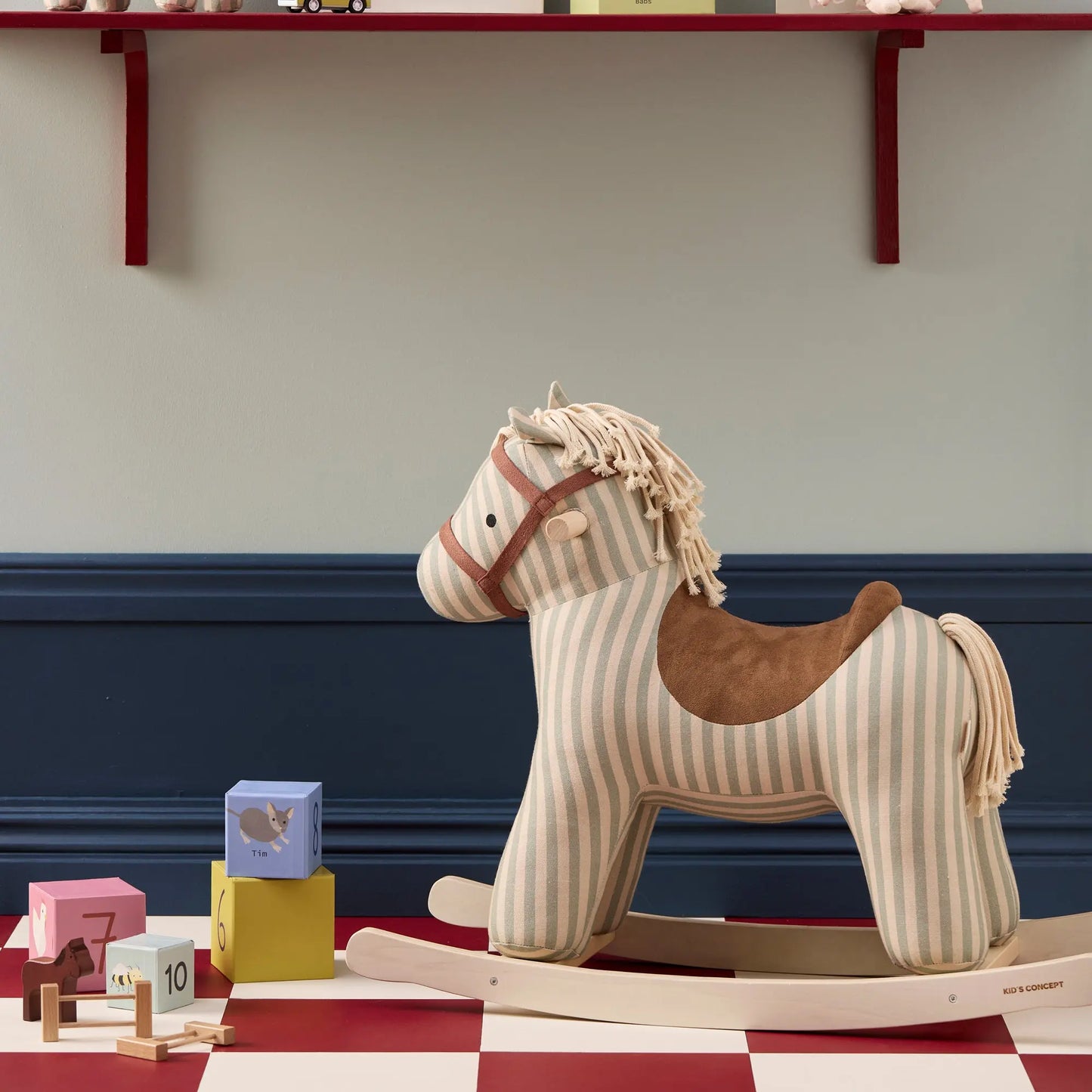 Rocking horse Sam toy with children's building blocks next to him