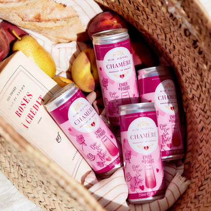 Wicker basket with four cans of Chamère inside.