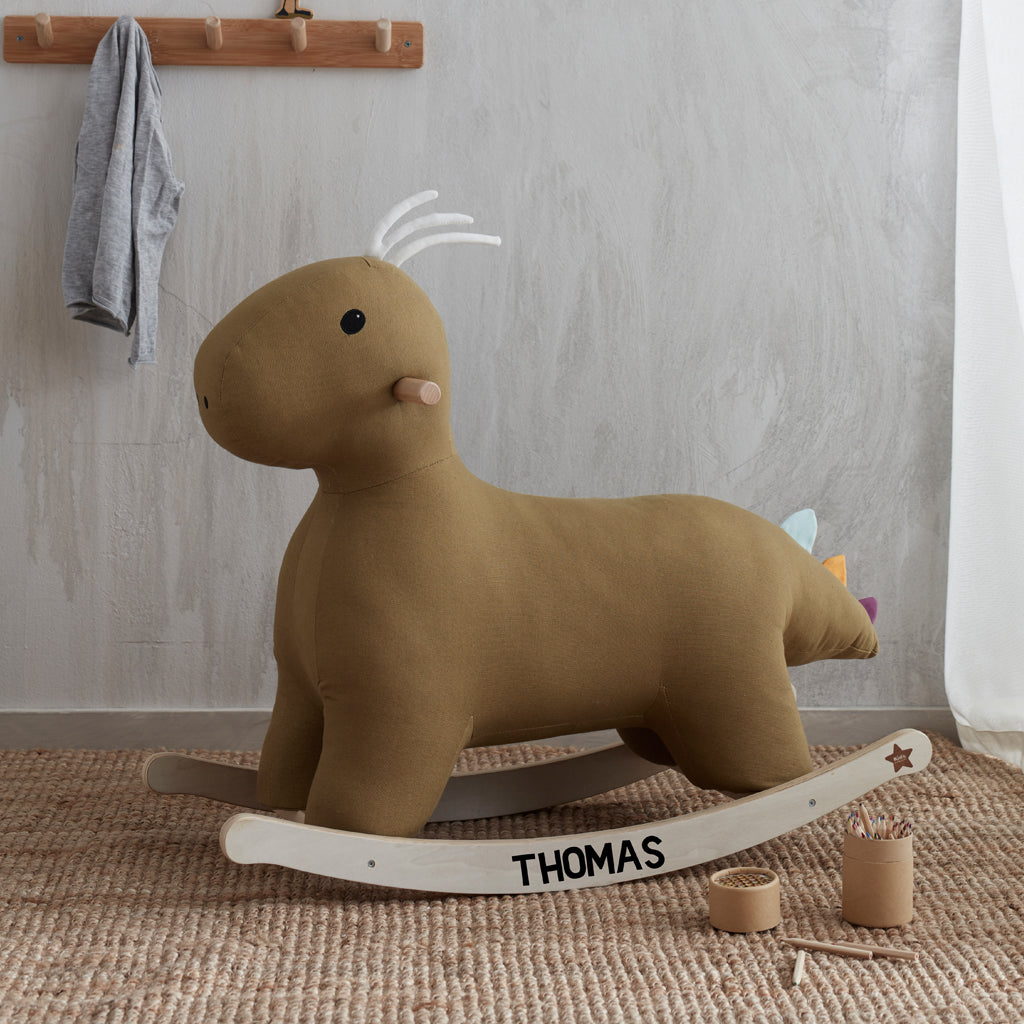 Dinosaur rocking toy with the name Thomas printed on the rockers