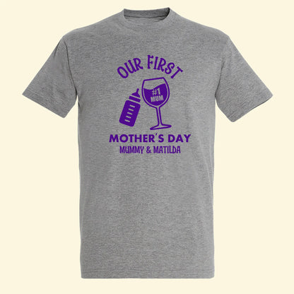 Grey adults t shirt with design of Our First Mother's Day Mummy & Matilda. With a baby bottle and wine glass tilted together. Printed in purple