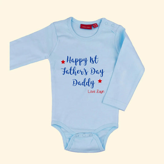 Light blue bodysuit with design that reads Happy 1st Father's Day Daddy printed in royal blue and love Zayn with two stars printed in red