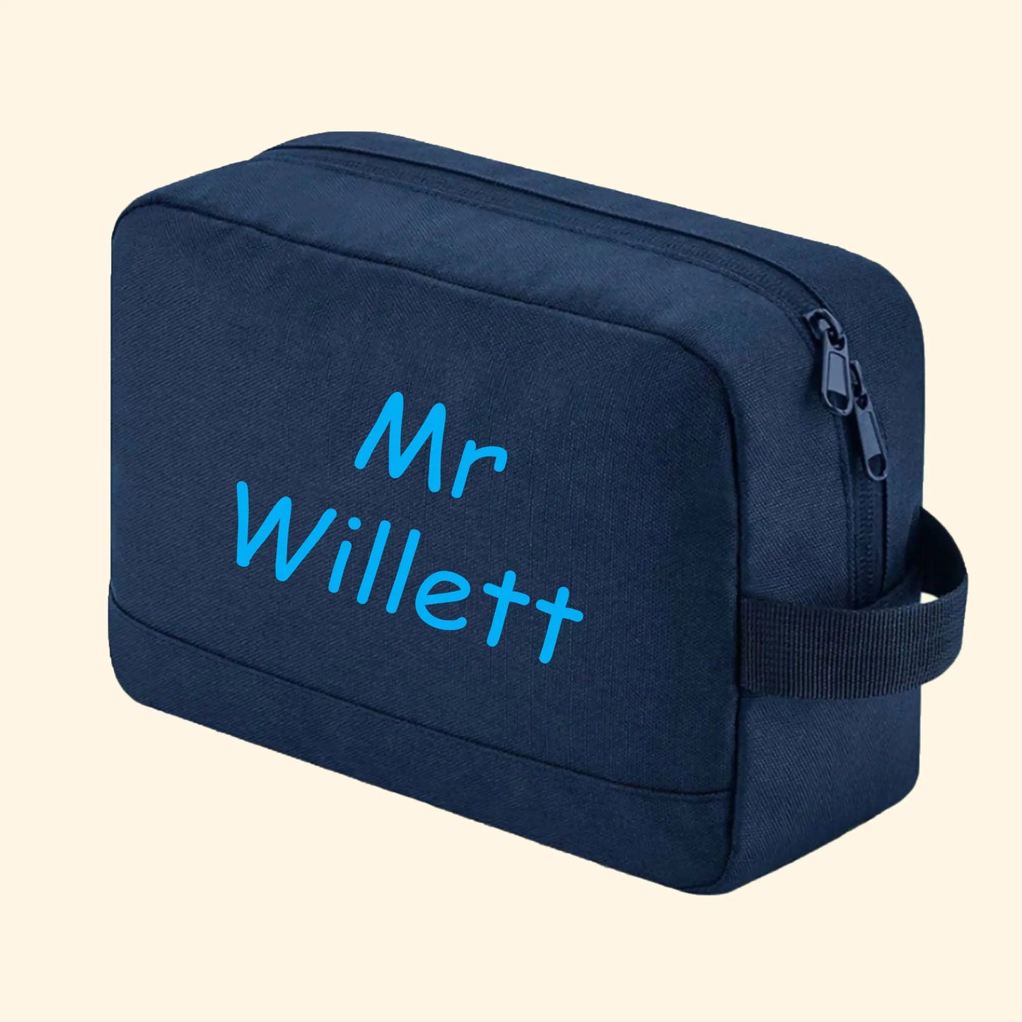 Navy wash bag with Mr Willett printed in comic sans in blue.