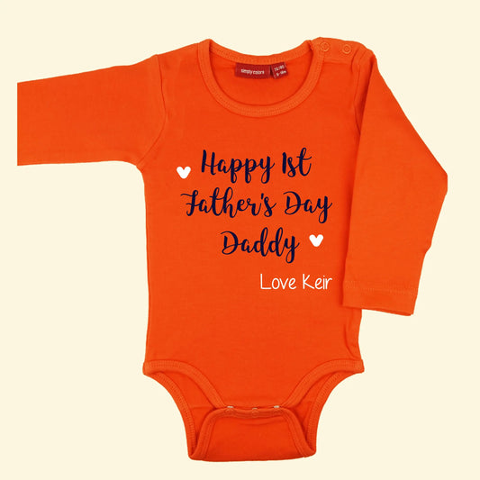 Orange bodysuit with design that reads Happy 1st Father's Day Daddy printed in navy and love Keir with two hearts printed in white