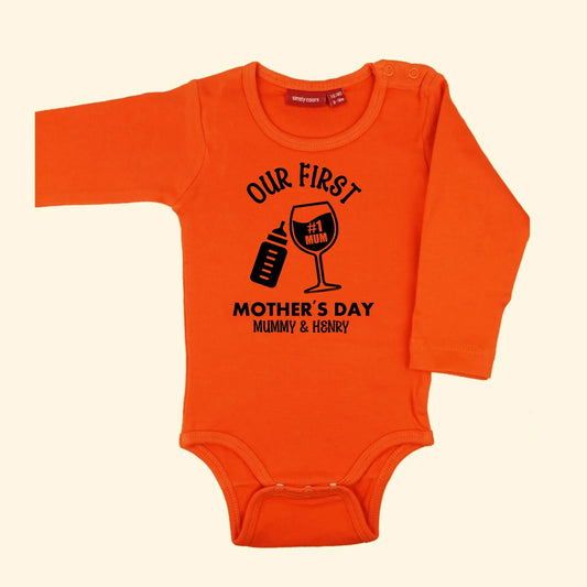 Orange bodysuit with design of Our First Mother's Day Mummy & Henry. With a baby bottle and wine glass tilted together. Printed in black.