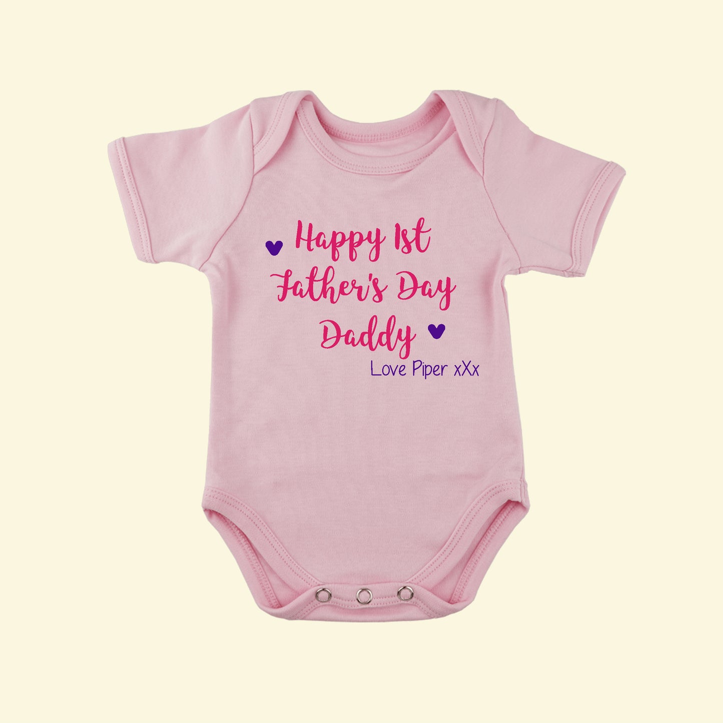 Light pink babygrow with the text Happy 1st Father's Day Daddy Love Piper xxx printed on the front with 2 hearts. Lovely Fathers day gift