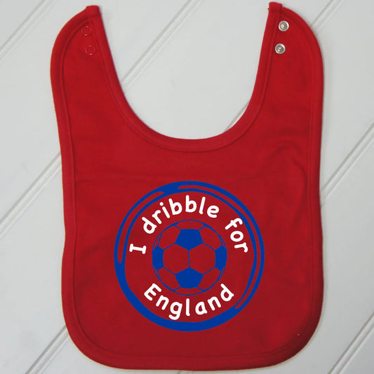 Red bib with a design of a football printed in royal blue and two lines of curved text. Top line reads I dribble for, second line reads England. Both printed in white.