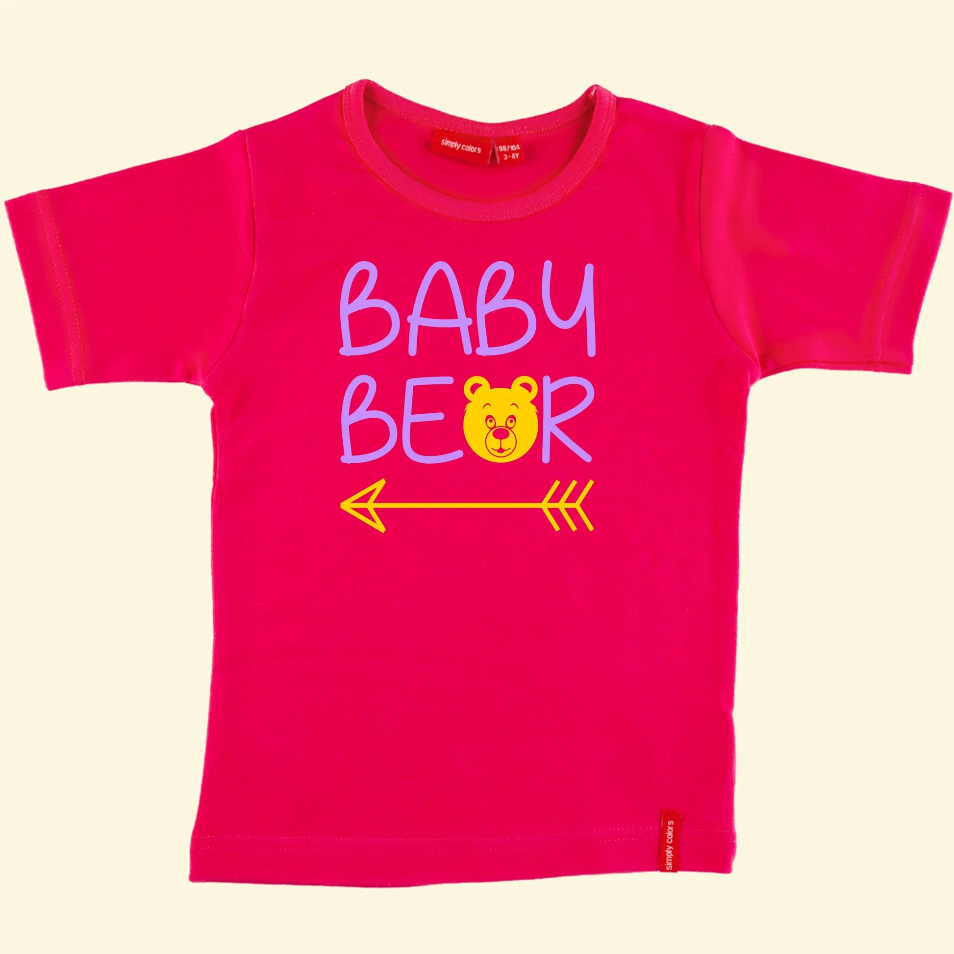 Kids pink t shirt with top line of text reading Baby and the second reading bear but with the a replaced with a bear face and an arrow under the whole design, text printed in lilac and bear /  arrow in yellow.