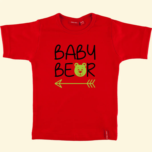 Kids red t shirt with top line of text reading Baby and the second reading bear but with the a replaced with a bear face and an arrow under the whole design, text printed in black and bear /  arrow in apple.