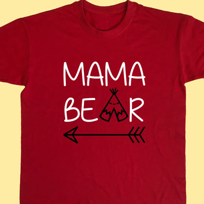 Red adult t shirt with top line of text reading Mama and the second reading bear but with the a replaced with a teepee and an arrow under the whole design. Printed in two colours text printed in white and teepee and arrow in black.
