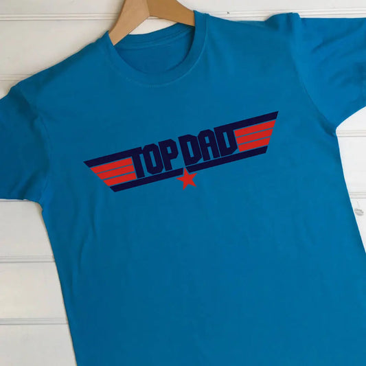 Aqua blue adult's t shirt with a top dad design on the front styled in the top gun theme. Top dad is printed in navy and the stripes and star are in red.