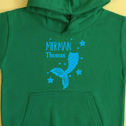Green hoodie with a merman design and the name Thomas printed in blue on the front