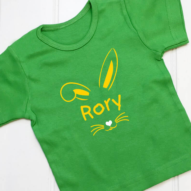 Green children's t shirt with a cute Easter bunny design with the name Rory printed in yellow on the front of the t shirt