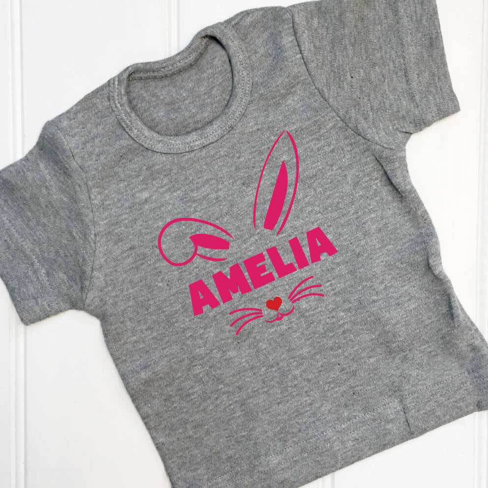 Grey kids t shirt with an easter bunny design and the name Amelia printed on the front in pink vinyl