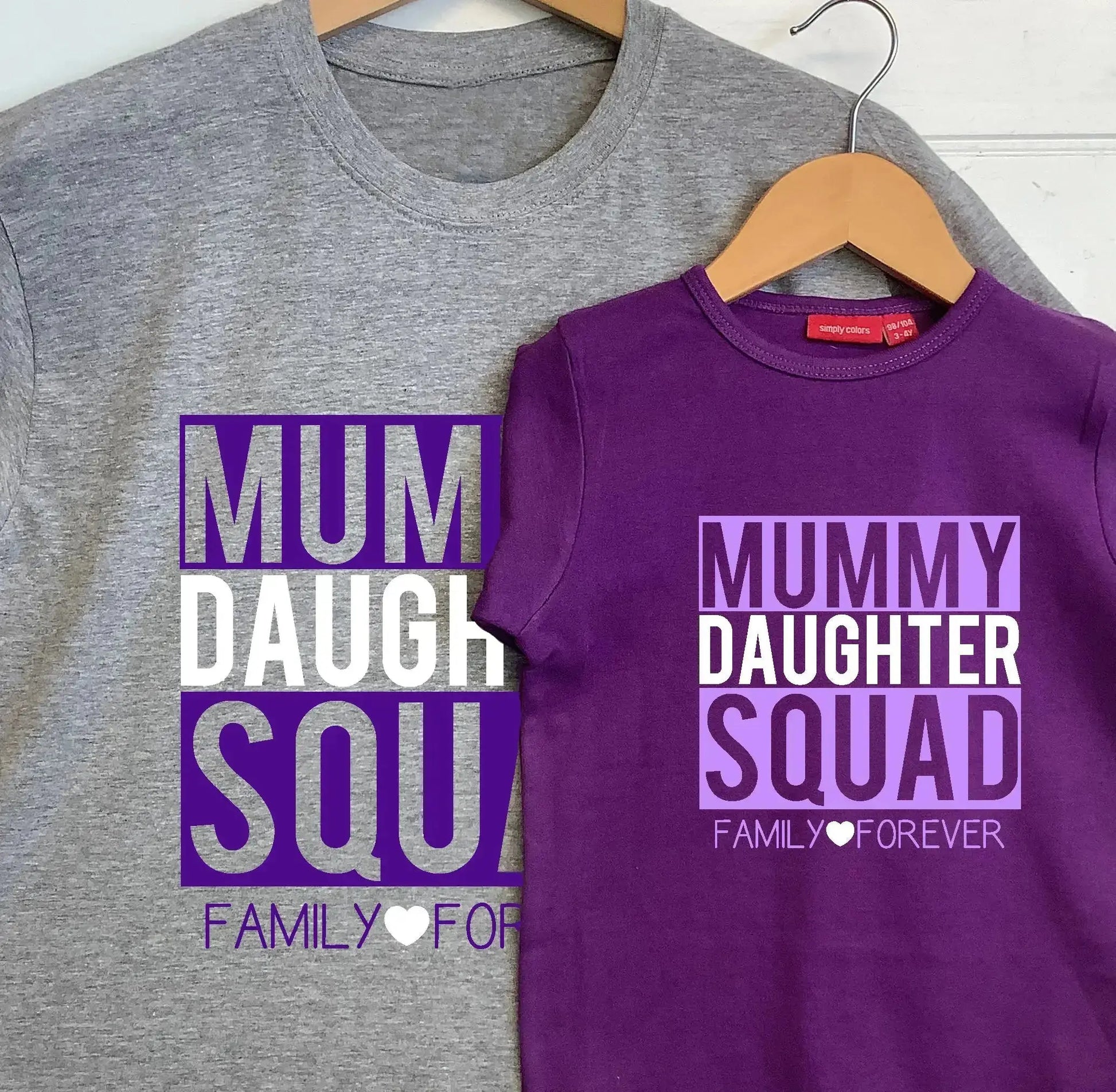 Grey Adult t shirt with Mummy, Squad, Family Forever printed in purple and Daughter and heart printed in white, with kids purple t shirt  with Mummy, Squad, Family Forever printed in lilac and Daughter and heart printed in white