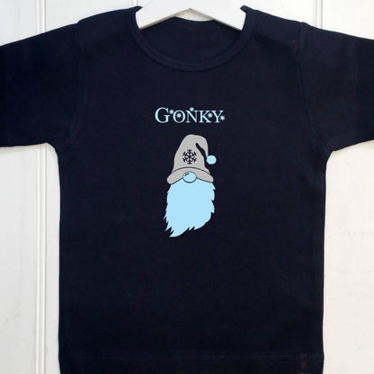 Navy blue kids t shirt with the text Gonky and a gonk printed on the front. The text and gonk's beard are light blue and the hat which has a snowflake design on is printed in silver. These t shirts are a great fun Christmas gift.