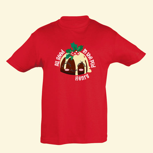 Red t shirt with a Christmas pudding and 'All good in the pud' written around the pudding. The child's name is printed underneath.