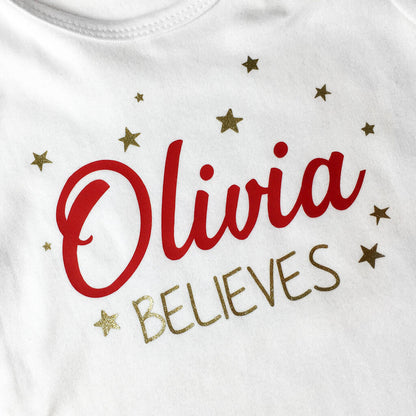 Close up of the Olivia Believes Christmas design, showing the red print and gold glitter stars