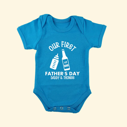 Aqua blue babygrow with Our first Father's Day Daddy & Thomas printed above and below a baby's milk bottle and a beer bottle with No. 1 Dad on the label