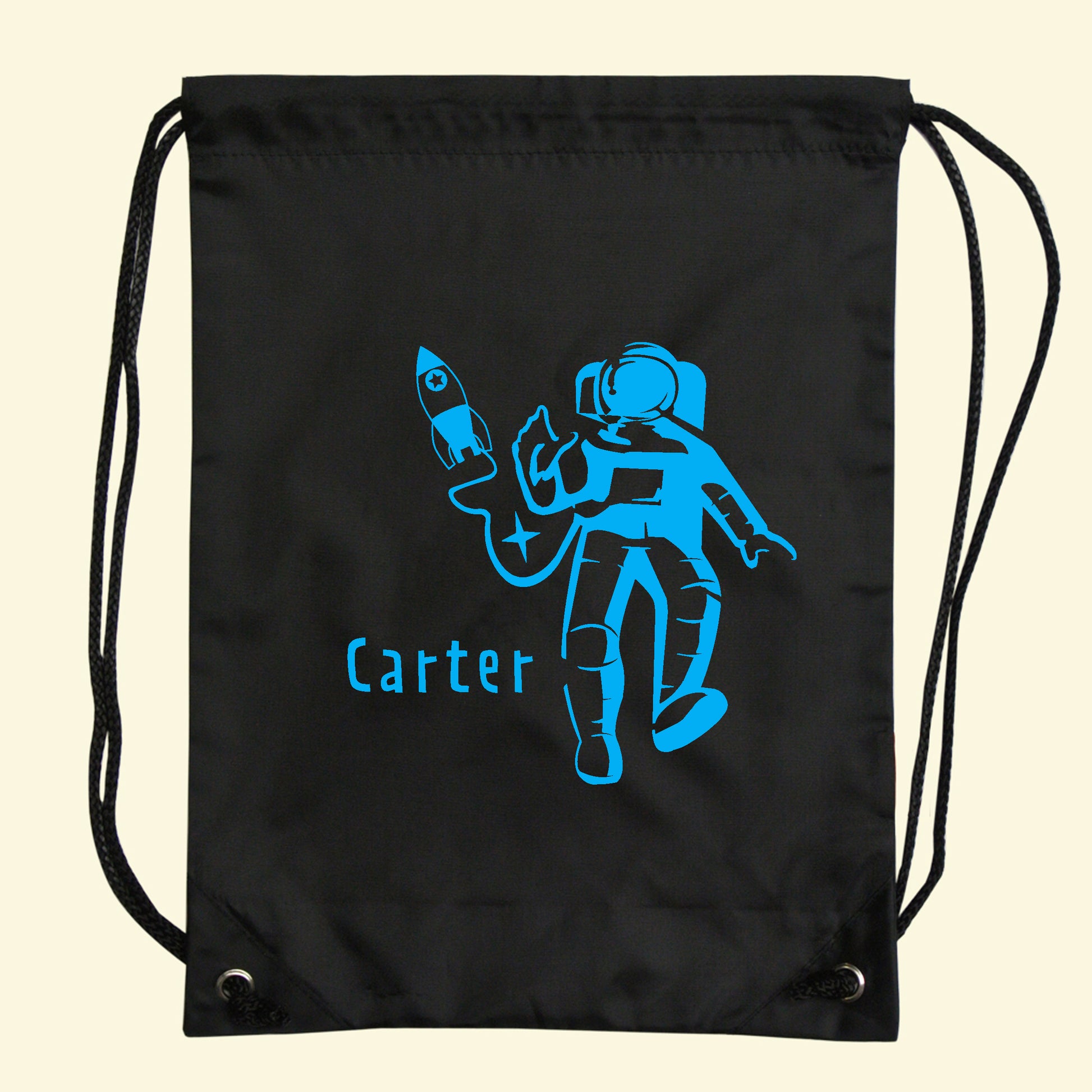 Black gym - swim bag with an astronaut and rocket design with the name Carter printed on the front in blue