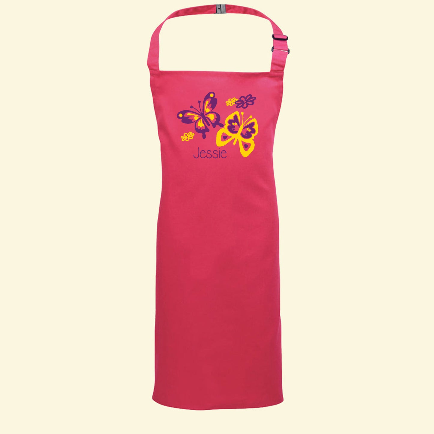 Pink apron with a butterfly design printed in purple and yellow colours and the name Jessie