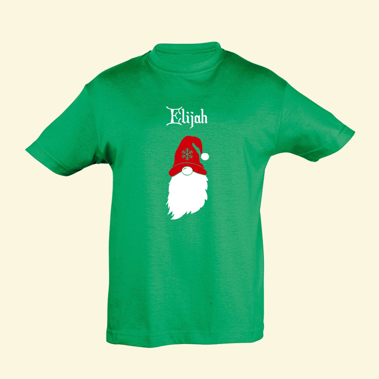 Green t shirt with a gonk design on the front and the name Elijah. The gonk is printed in white and wears a red hat with a snowflake design.