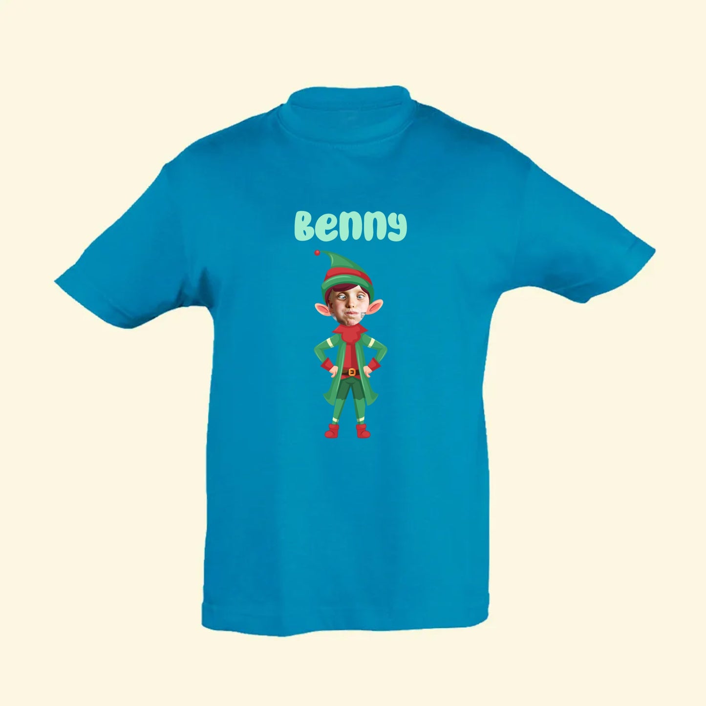 Aqua blue t shirt with an elf image with the face a picture of the recipients face. The name Benny is printed above the elf on the front of the t shirt