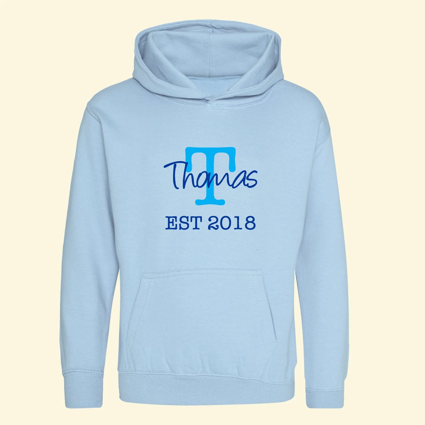 Light blue hoodie with a capital T in blue and the name Thomas printed across the T in royal blue and EST 2018 in royal blue underneath on the front