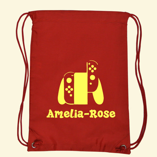 Red gym swim bag with a game controller and the name Amelia-Rose in yellow print on the front