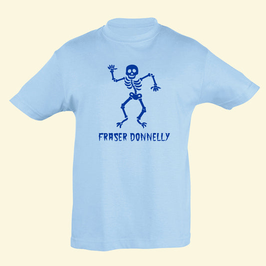 Light blue t shirt with a smiley skeleton with the name Fraser Donnelly underneath printed on the front in royal blue