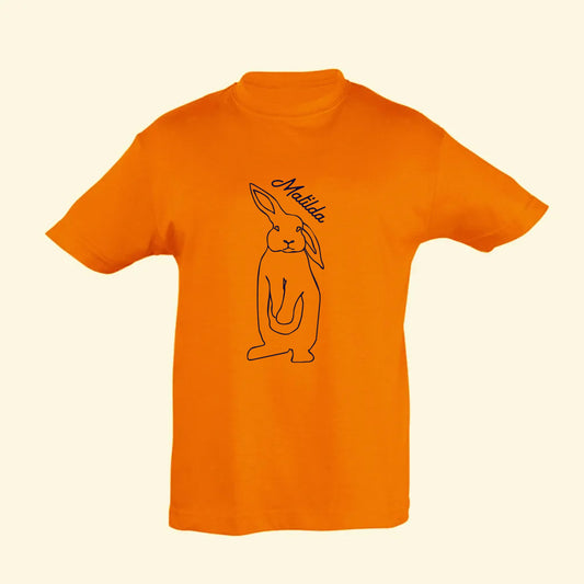 Orange t shirt with a hand drawn outline of a rabbit and the name Matilda on the front