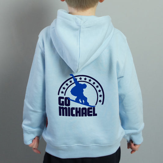 Child wearing a light blue hoodie with a snowboarder and Go Michael printed on the back