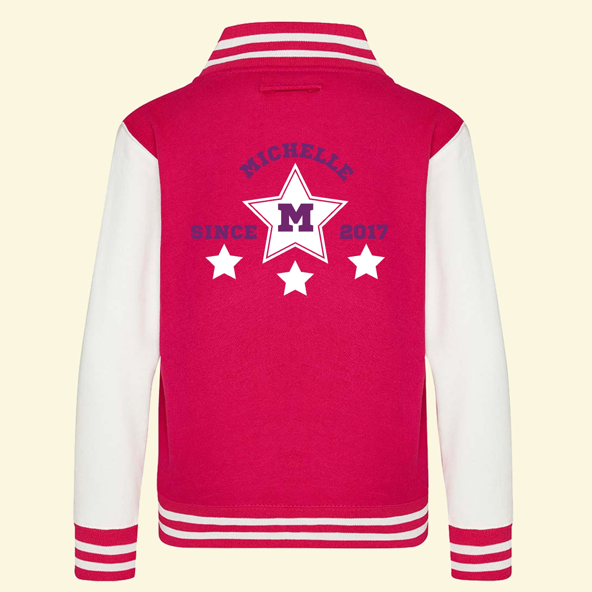 Pink varsity jacket with white sleeves. On the back is a star design and the text Michelle, M and since 2017.