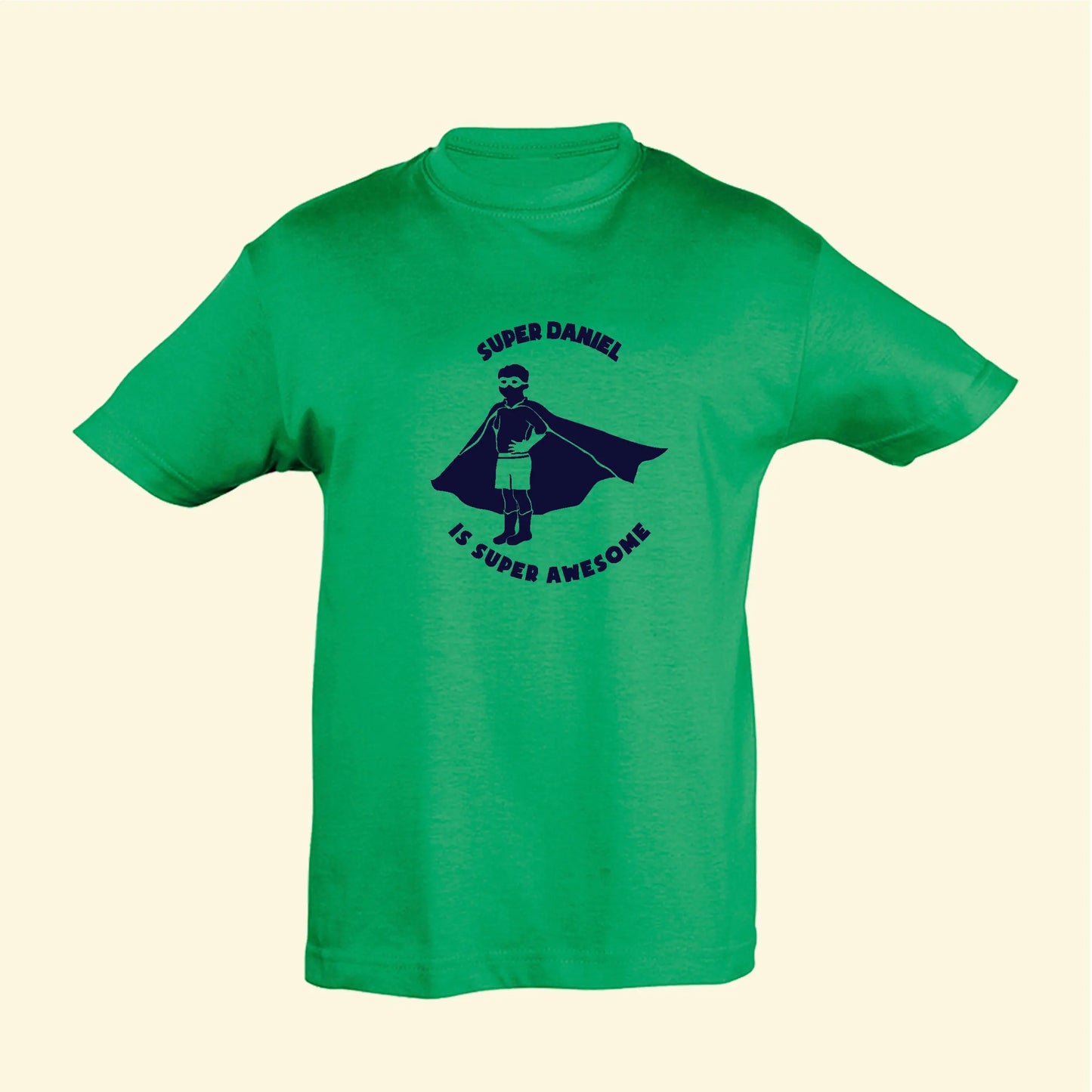 Green t shirt with a super hero illustration and the text Super Daniel Is Super Awesome, printed on the front in navy blue