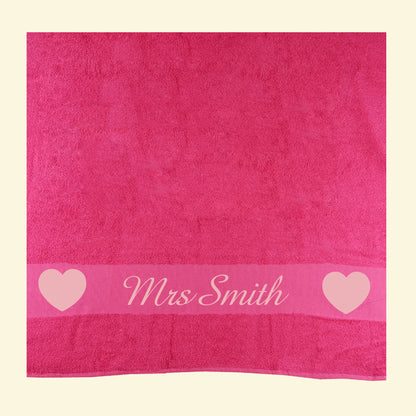 Pink towel with Mrs Smith printed in the middle of two light pink hearts