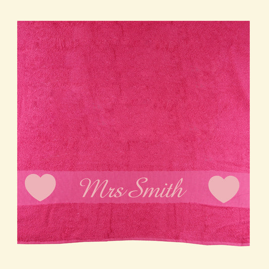 Pink towel with Mrs Smith printed in the middle of two light pink hearts