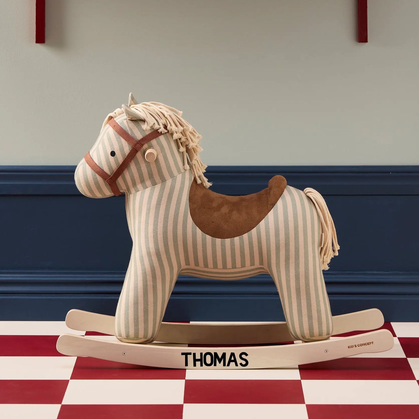 Rocking horse Sam toy personalised with the name Thomas on the rockers. The horse Sam and cream and light blue/grey stripes, a cream mane and tail and brown saddle