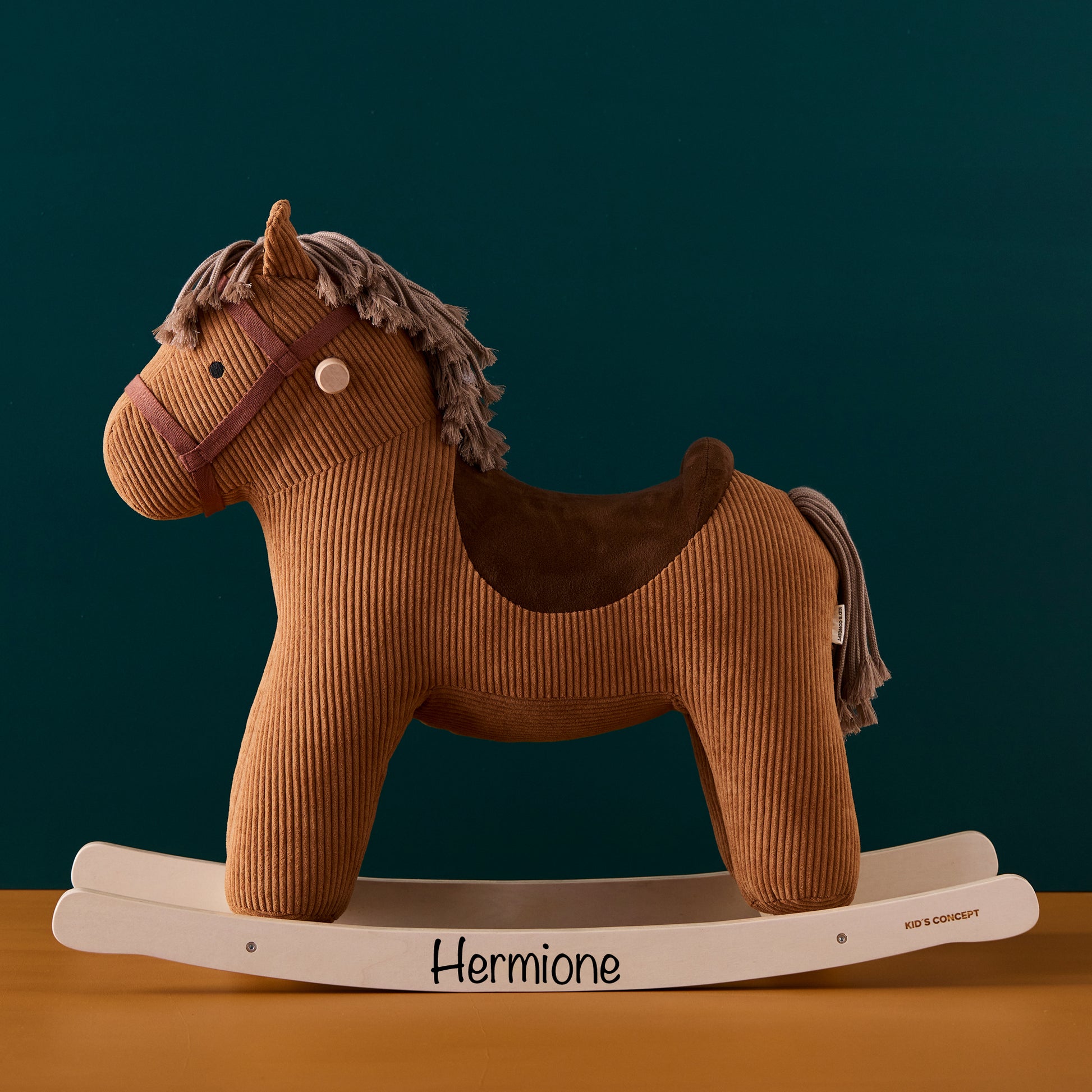 Personalised rocking horse Vera toy with the name Hermione printed on the rockers. Vera is a gorgeous rich brown colour, with a lighter brown mane and tail, and a dark brown saddle