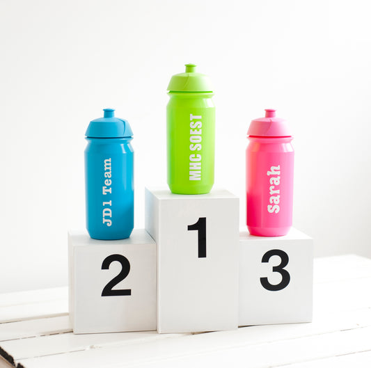 Sports water bottles on a podium, with 1, 2, 3. The bottles are lime green, pink, and aqua blue, each with personalised text on.