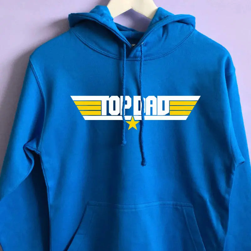 Aqua Blue hoodie with a top gun inspired design on the front with the text Top Dad, with a star and stripes either side. The main design in white with the stripes either side and star in yellow.