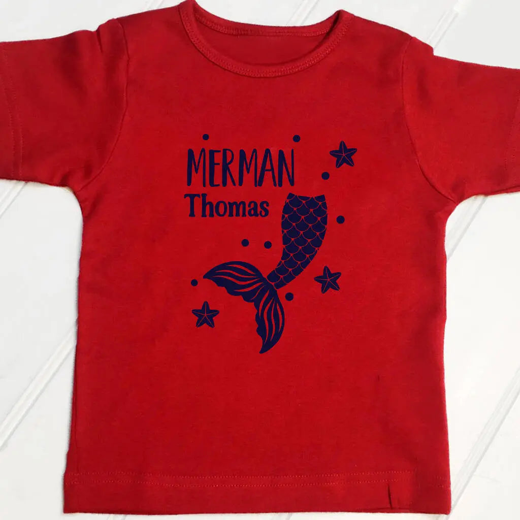Red t shirt with a Merman design and the name Thomas printed on the front in navy