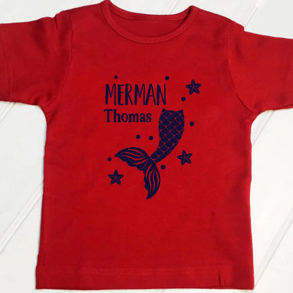 Red t shirt with a Merman design and the name Thomas printed on the front in navy