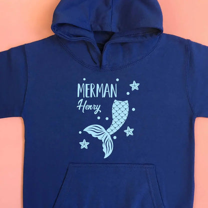 Royal blue hoodie with a merman tail and the name Henry with starfish scattered around the tail. Printed on the front with light blue