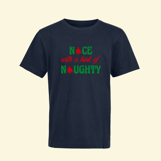 Navy child's t shirt with Nice with a hint of naughty printed in two print colours. Red and green. Christmas trees replace i in nice and a in naughty.