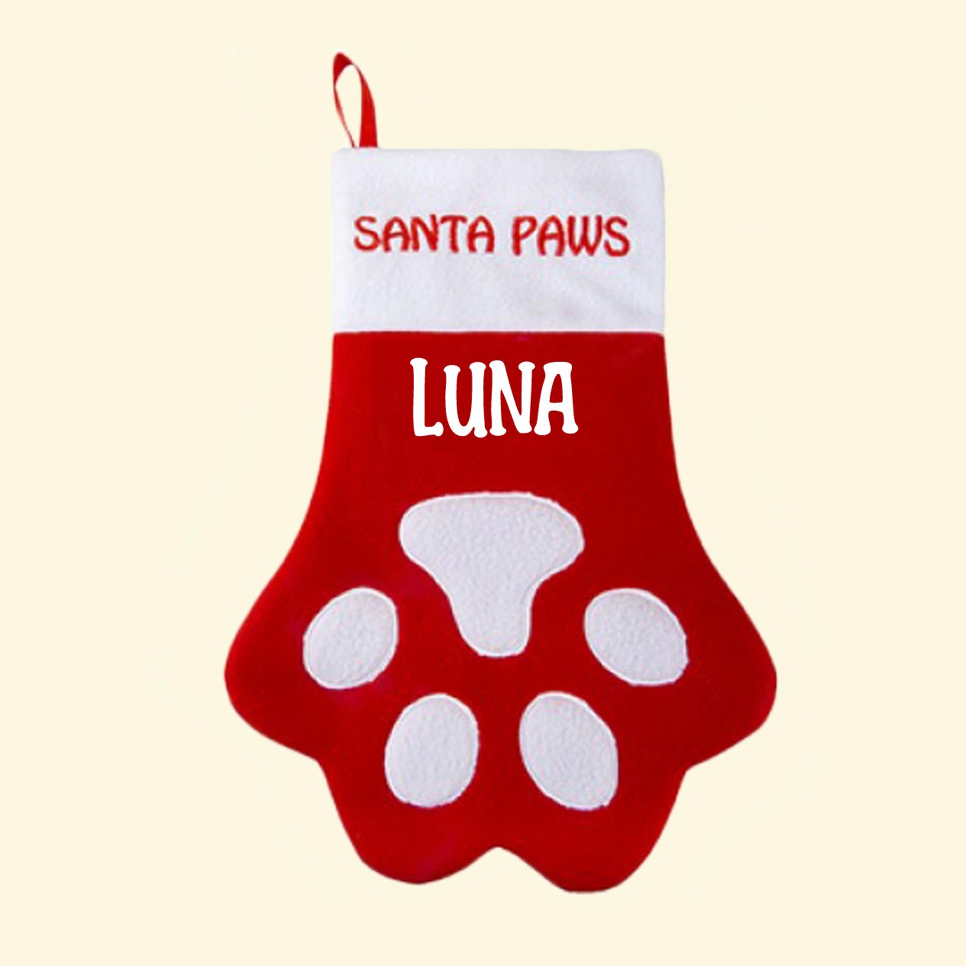 Red and white Christmas stocking with the bottom half in the shape of a paw with white applique. Santa Paws embroidered in red on the white trim and Luna printed in white underneath trim in white vinyl. 