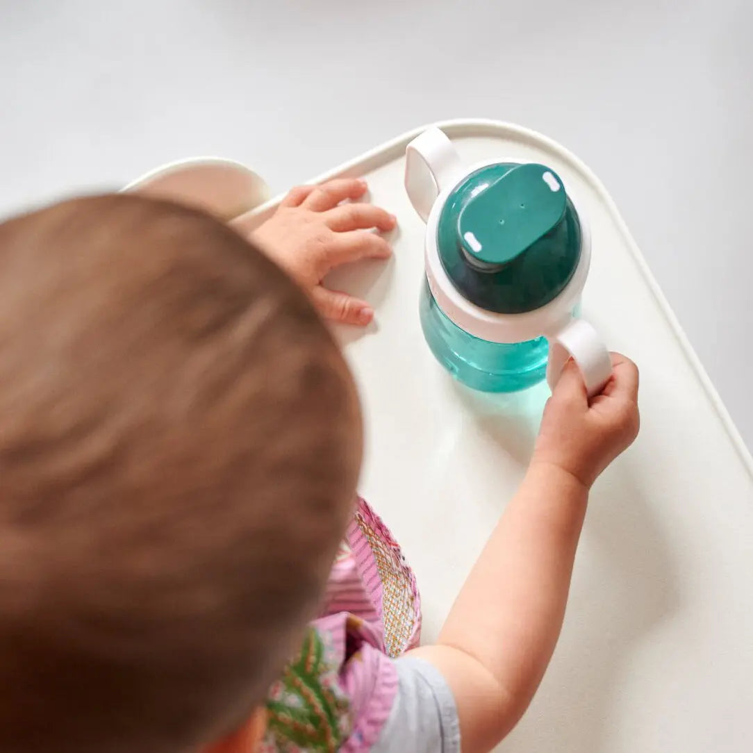 view of the top of the sippy cup, as a child holds it